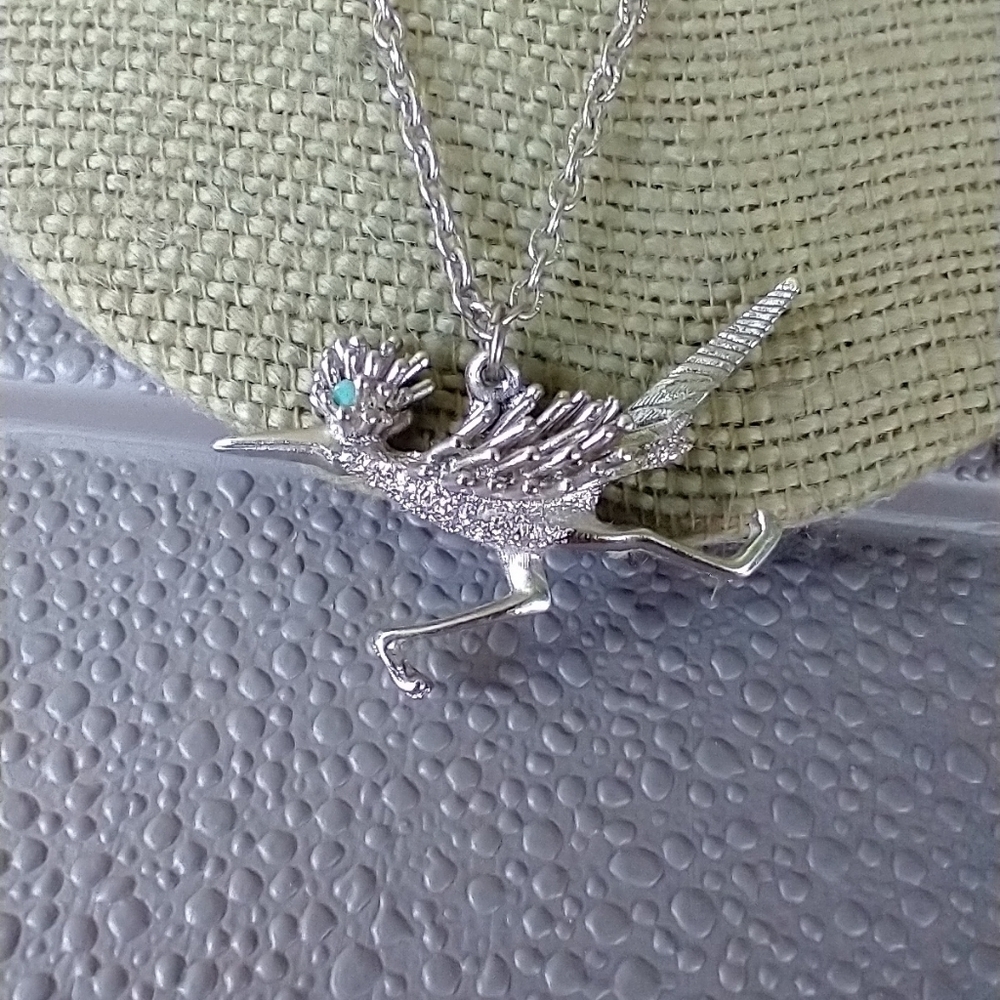 Women's road runner funny silver tone necklace.